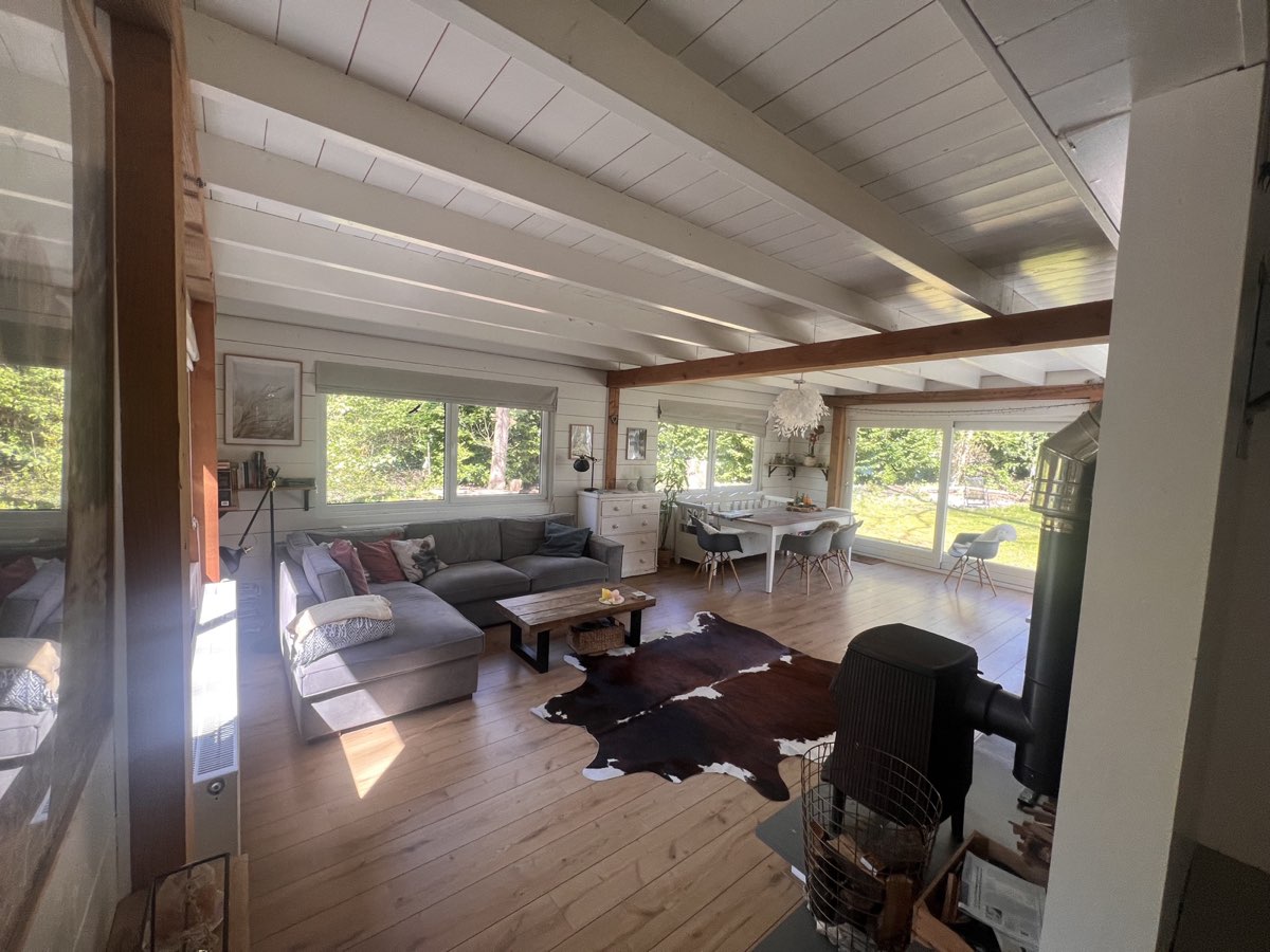 Woonkamer met loungebank en houtkachel